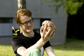 Preisträger Dr. Niklas Schwarz mit einem Modell des menschlichen Gehirns.