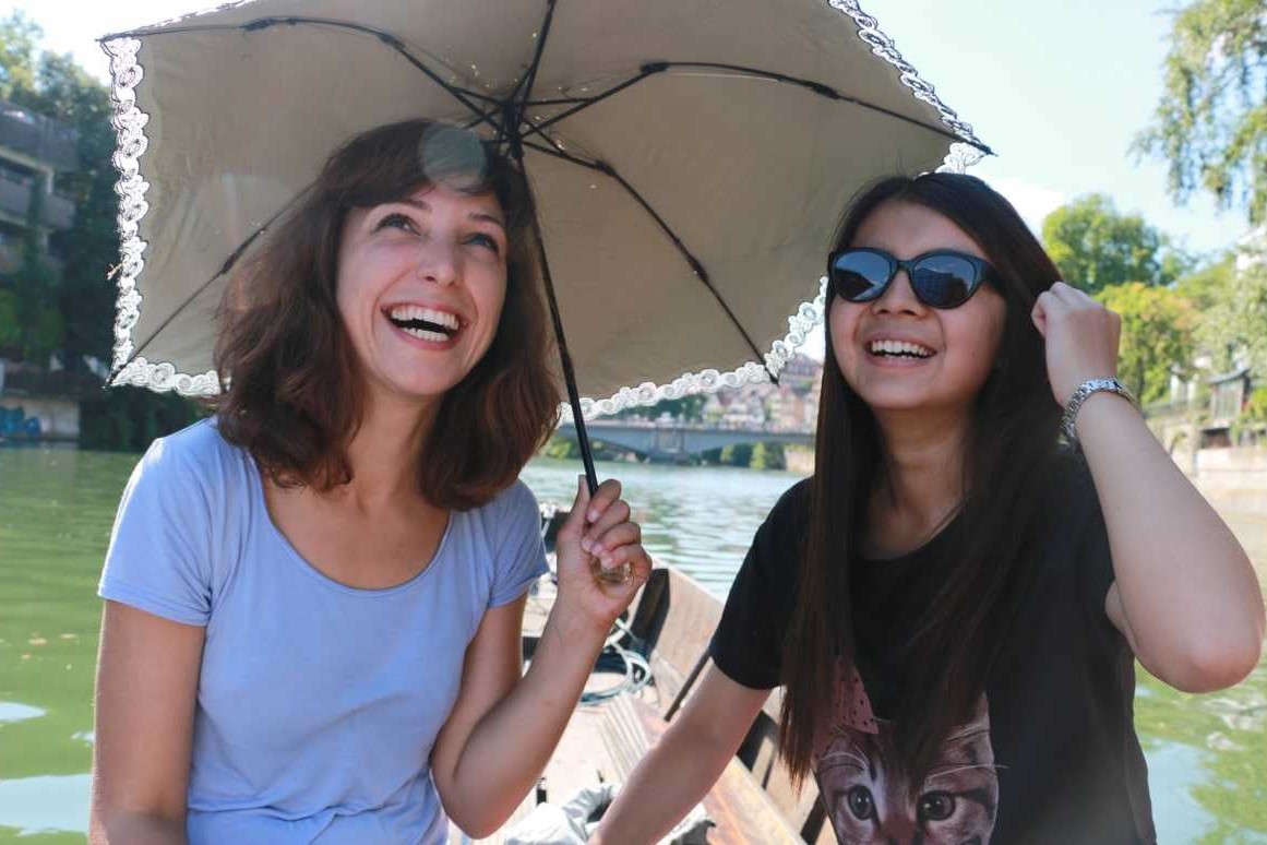 2 Studentinnen mit einem Sonnenschirm