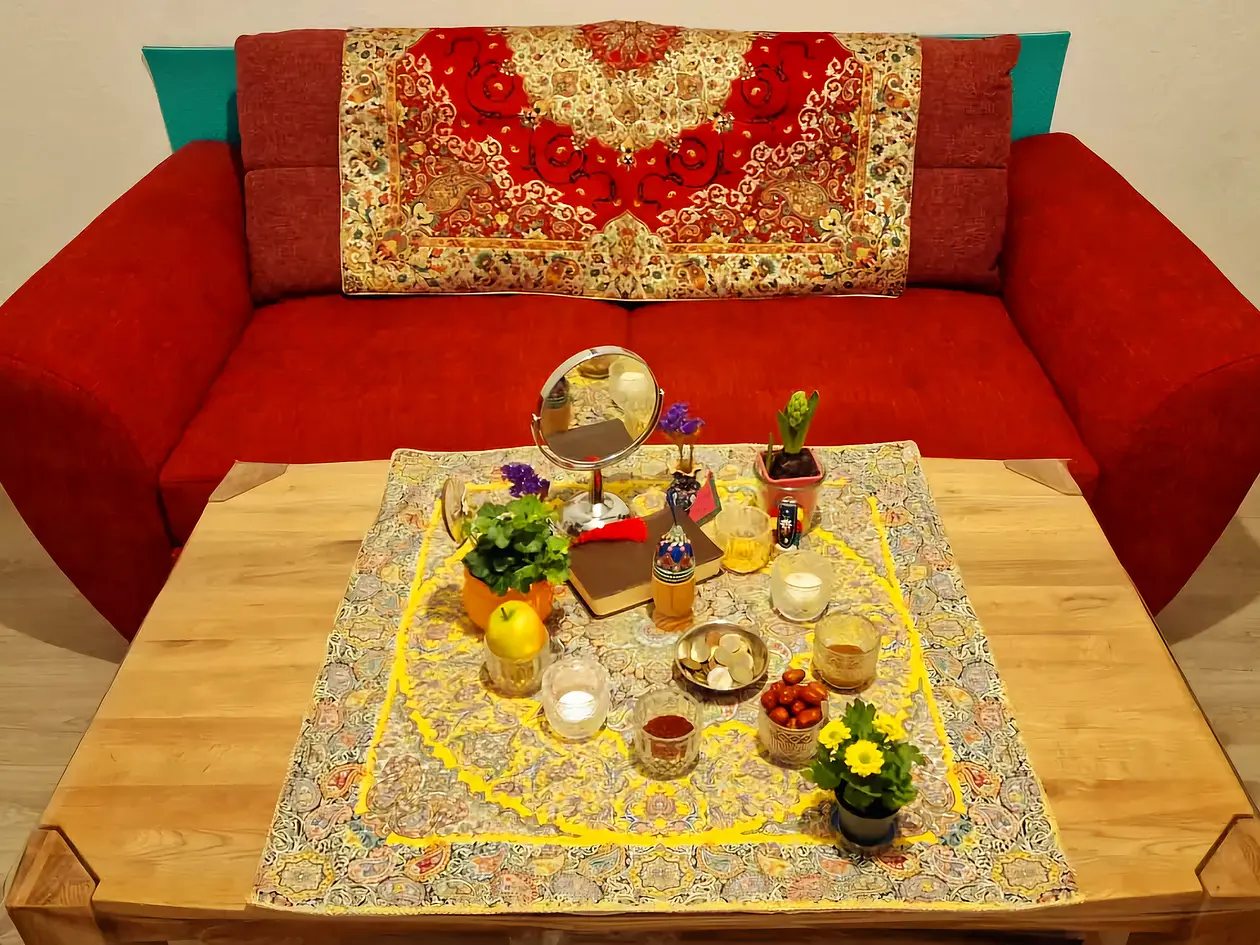 Picture of Haft-Seen table. The Haft-Seen table is a traditional setup used during Nowruz, the Persian New Year, symbolizing themes of renewal, growth, and prosperity. It typically includes seven items, each beginning with the Persian letter "S", each representing a different aspect of life and nature.