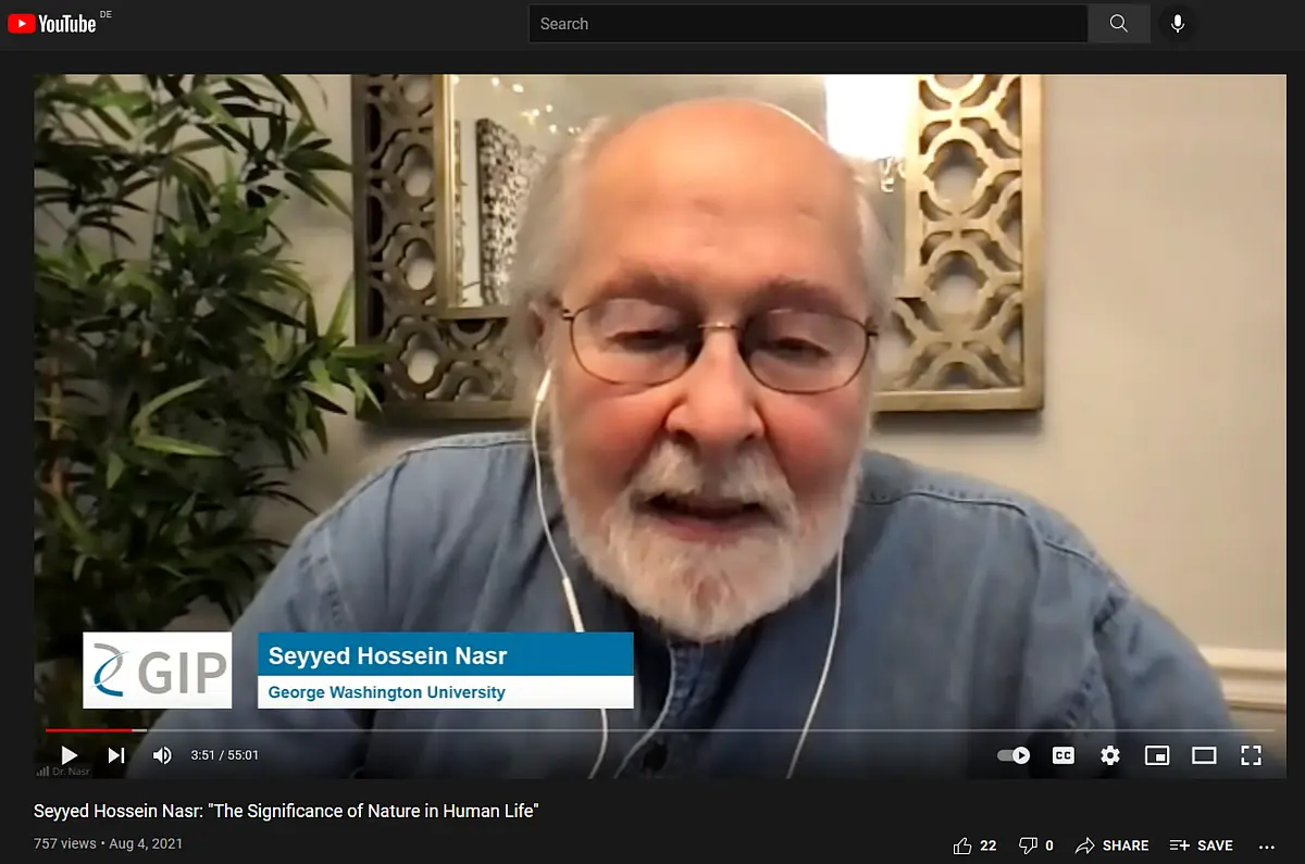 An older gentleman with white beard talking into a webcam