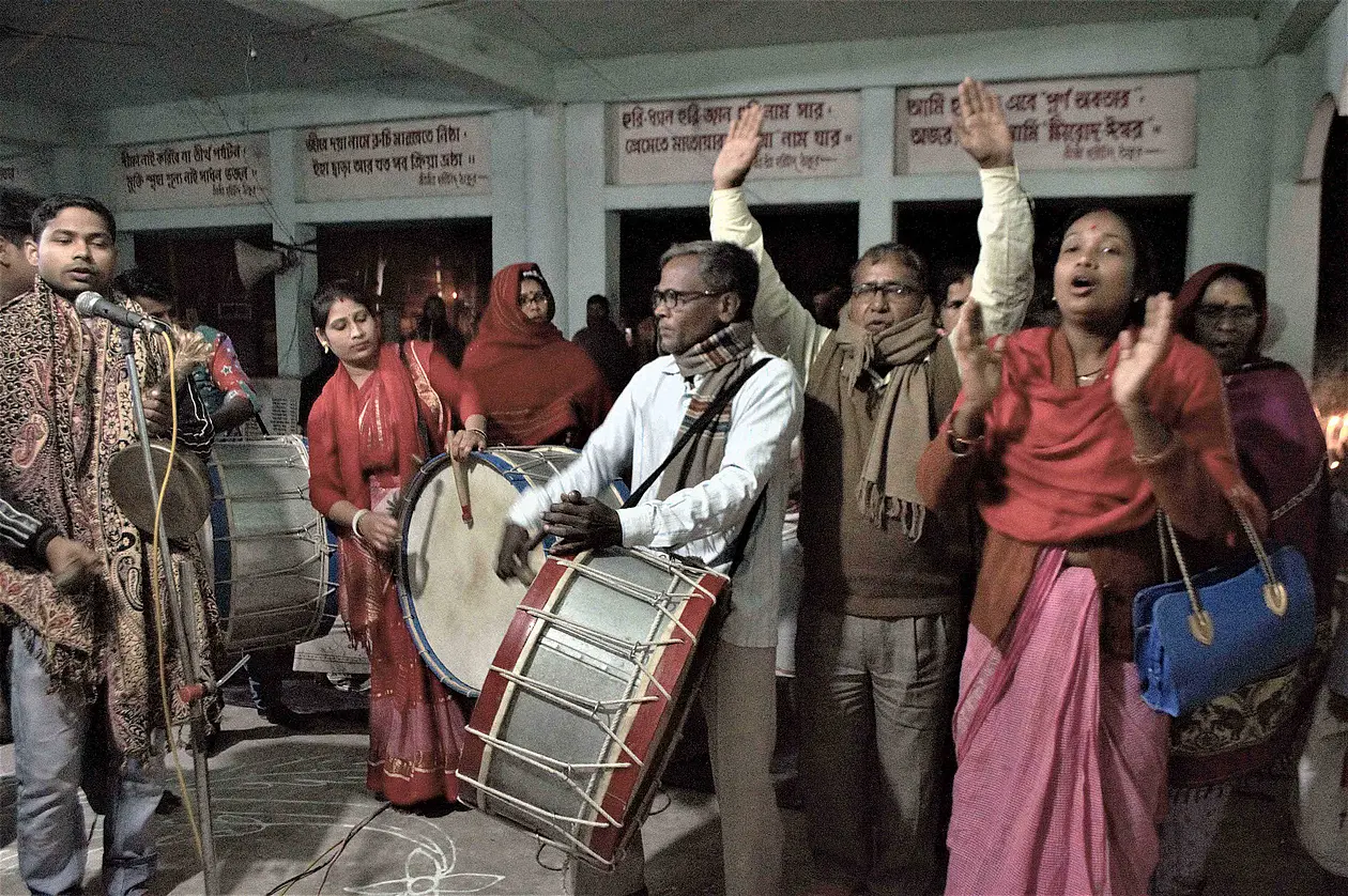People dancing and drumming at a ceremony.