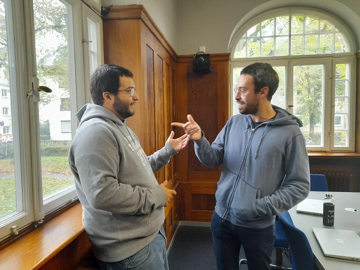 Picture of two male researchers having an academic debate. 