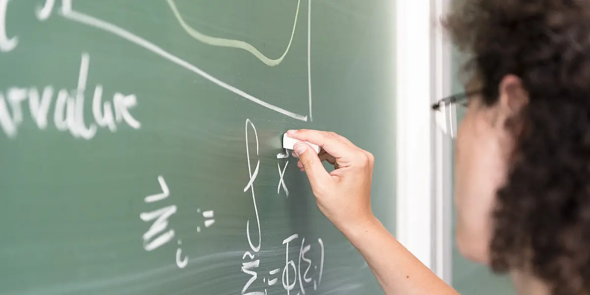 Lecturer writing on a blackboard