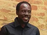 A young man with dark hair and short beard