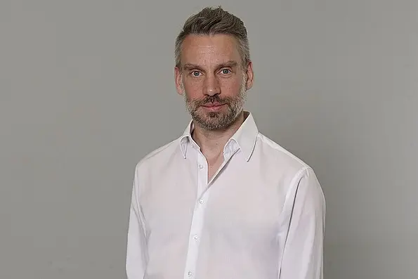 Prof. Dr. Wolfgang Gaissmaier vor einfarbigem Hintergrund