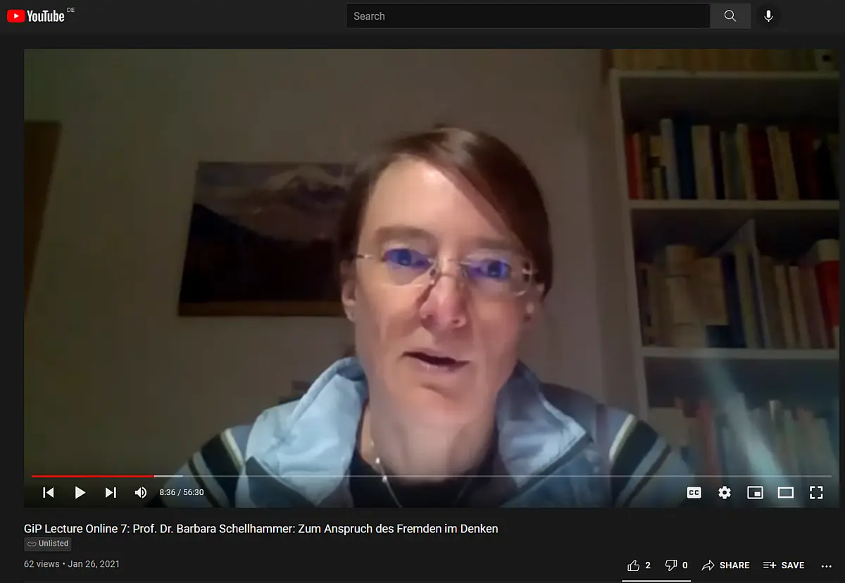 A dark blonde middle aged woman talking into a webcam