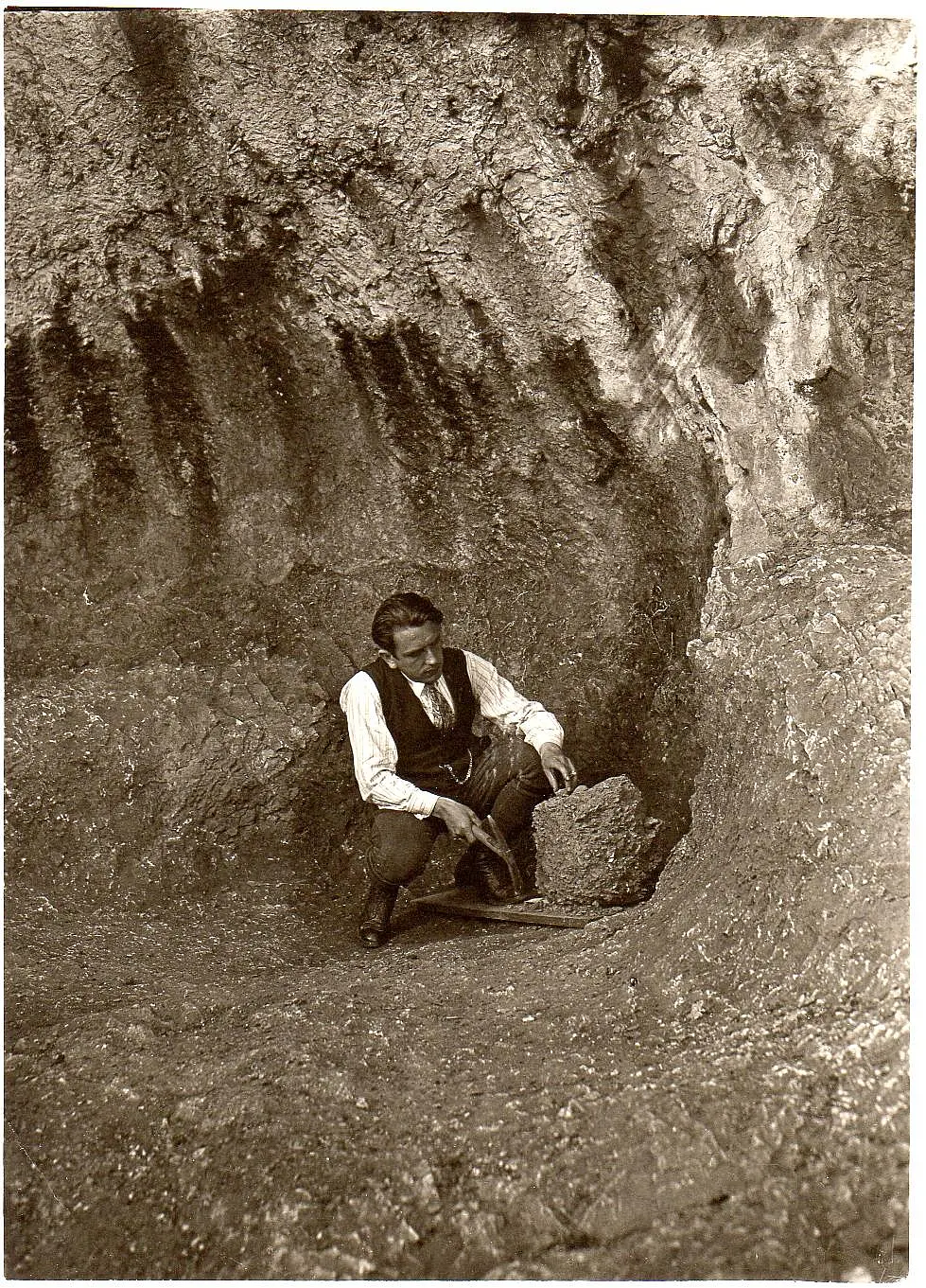 Archaeologist with tool at excavation site