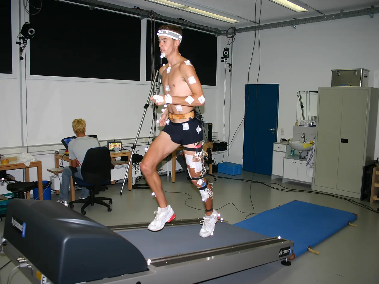 An athlete collects wired data on a treadmill