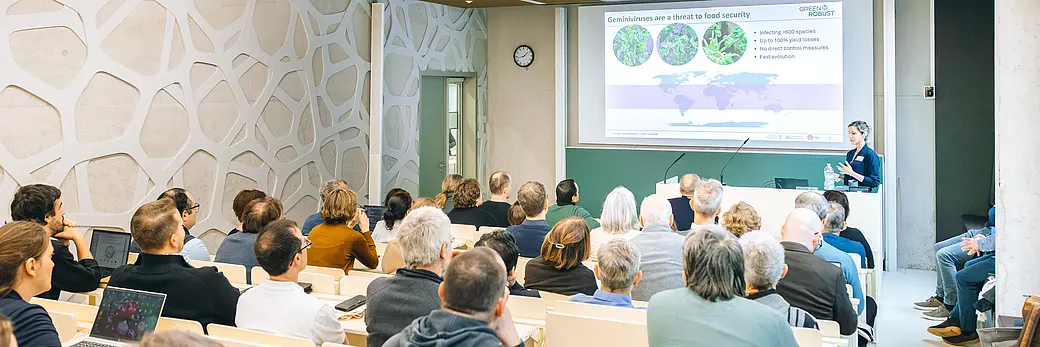 A seminar room filled with students listening to a presentation by a professor