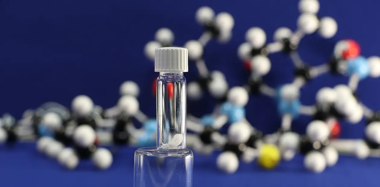 Laboratory-synthesized lugdunin and its model structure in the background. 