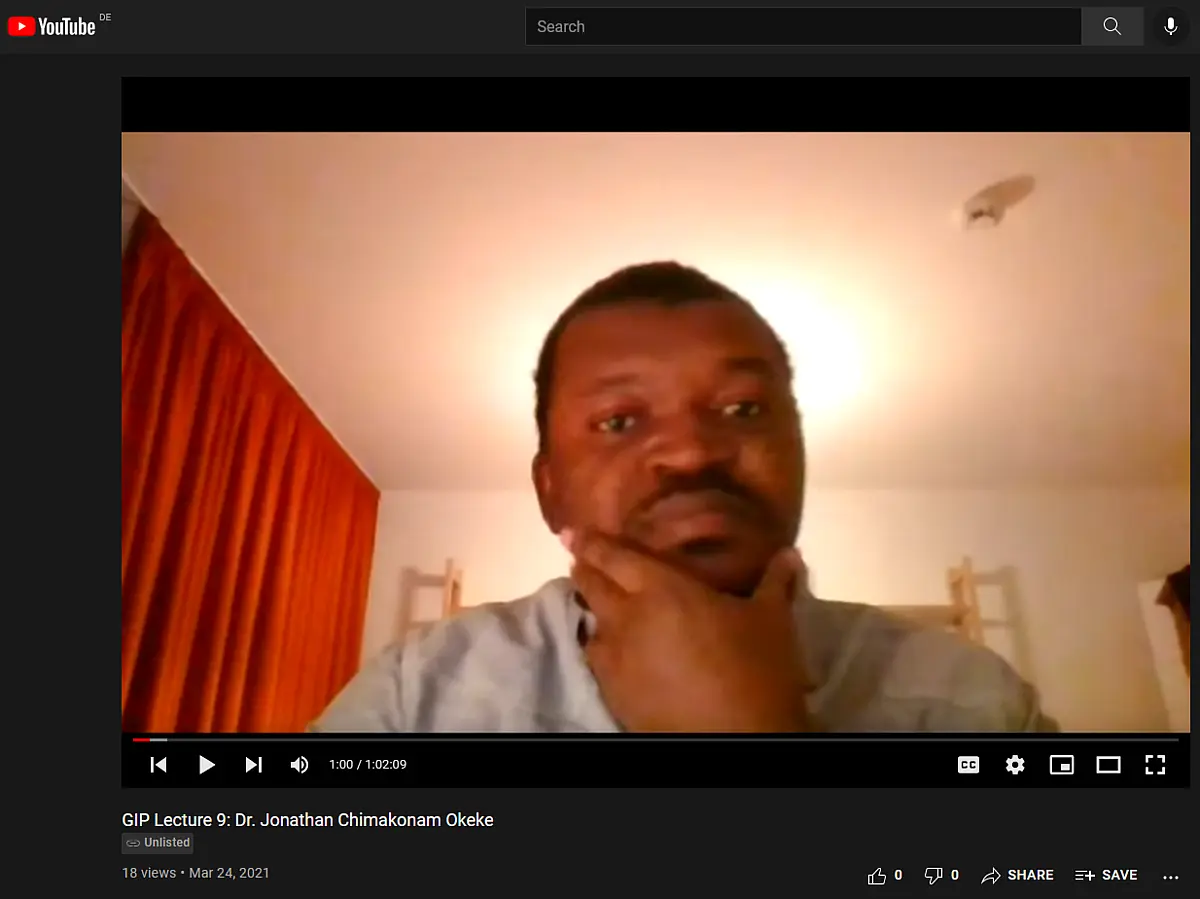 A young man with dark hair talking into a webcam