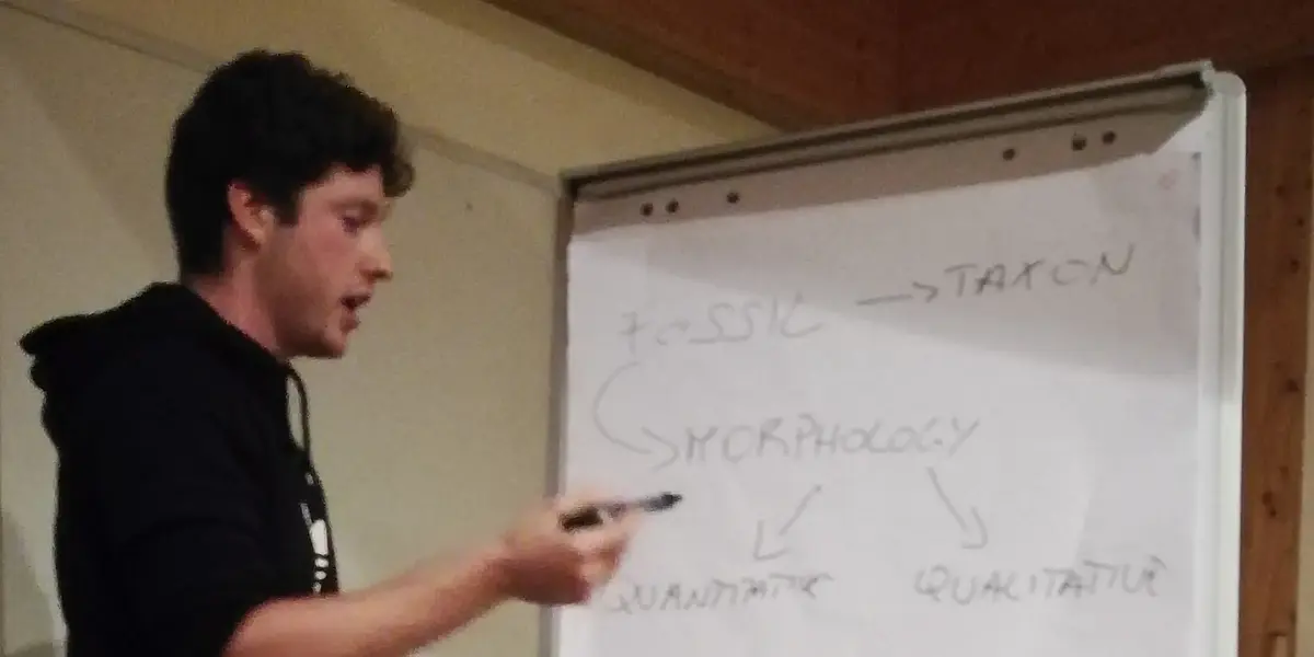An EVEREST student presenting his research with a flipchart during the PhD retreat in 2018
