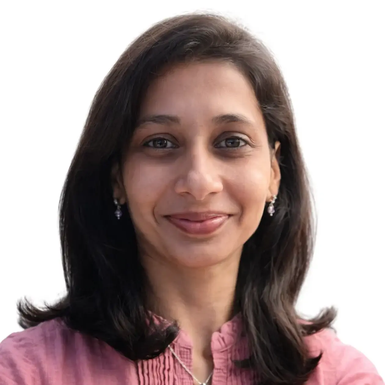 A profile photo of Rutu Gole, a brown woman with medium long dark brown hair smiling into the camera, wearing a light pink blouse with ruffles. 