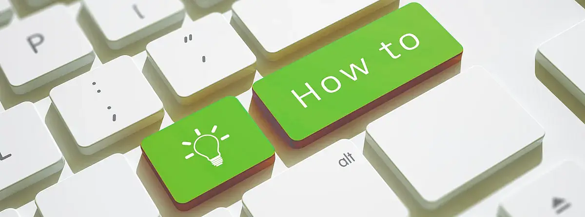 A section of a computer keyboard with a grenn key that says 'How to'.