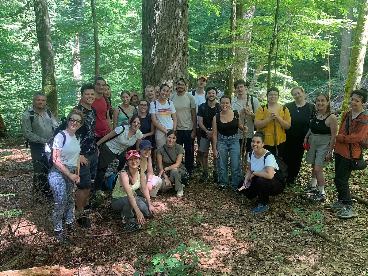 Gruppe von Studierenden und weiteren Teilnehmenden im Wald