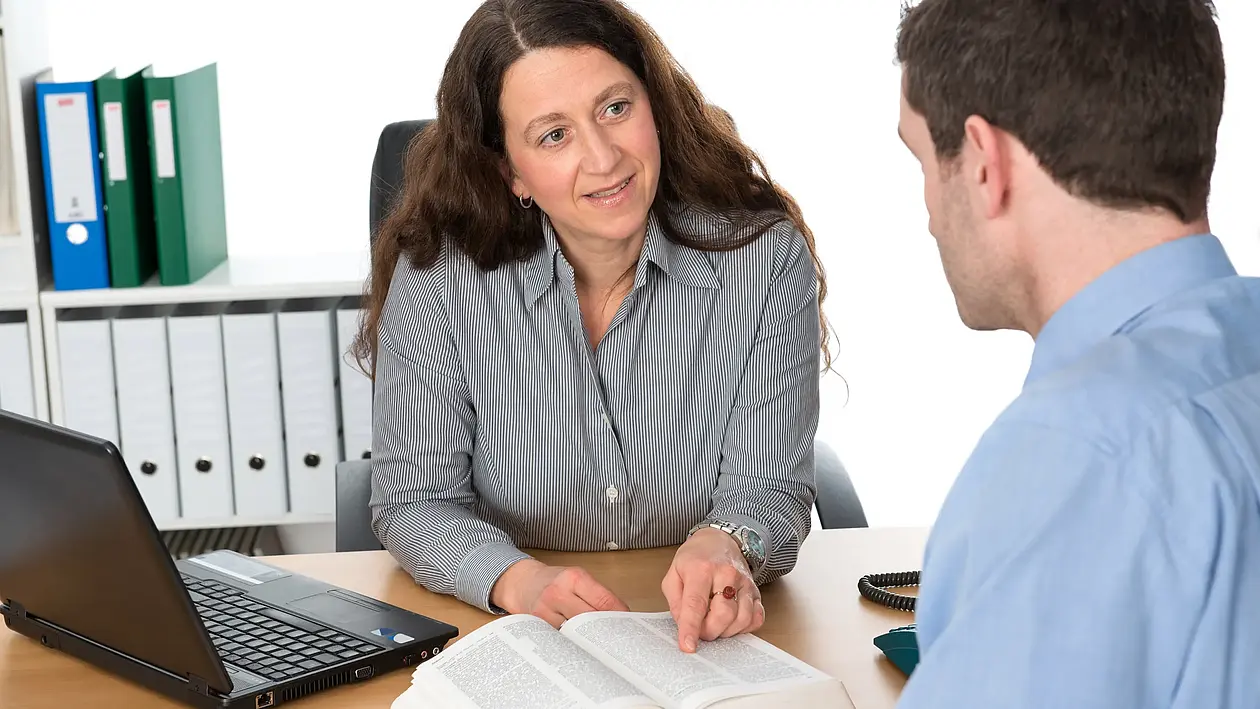 Woman and man at desk in a consultation