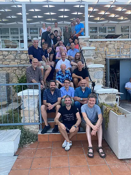 The symposium's participants standing on a stairway 