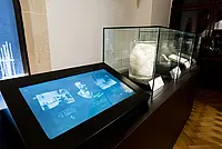 Auf dem Touchscreen lässt sich die Geschichte der Biochemie in Tübingen erkunden; daneben die Exponate zur Entdeckung der Nukleinsäuren durch Friedrich Miescher 1869.