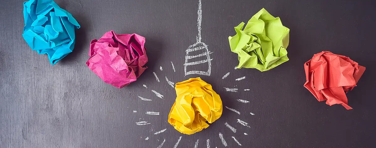 Colourful paper balls. One ball symbolises a light bulb.