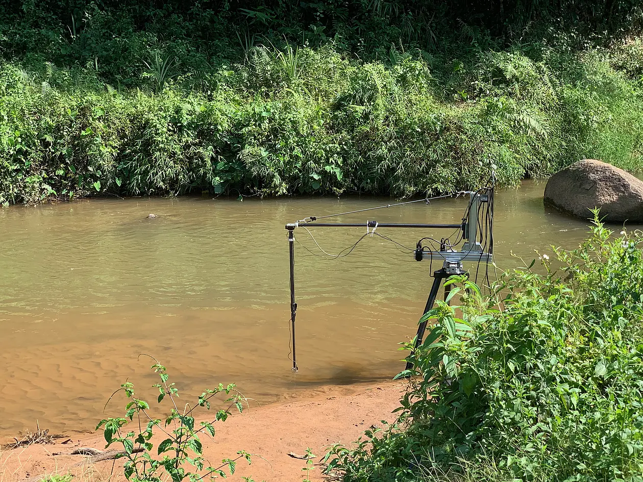 The photo shows a field site in Tumprop, India. Researchers use a robotic arm to control an underwater camera, which collects video data about zebrafish's native environment. 