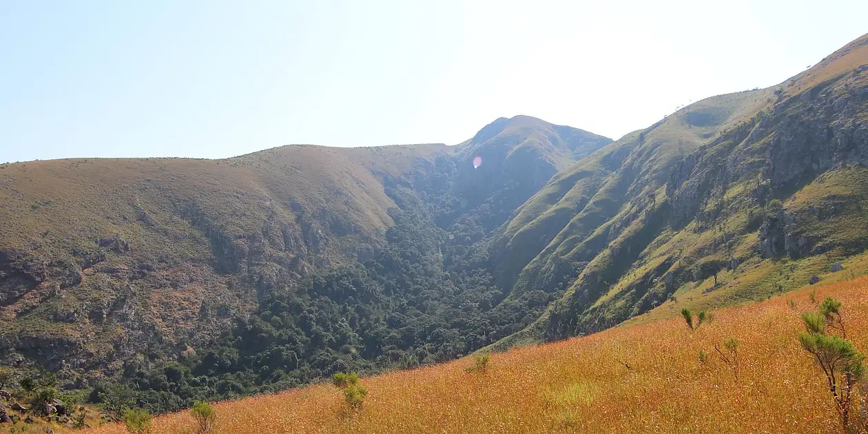 Photo of hilly landscape with rocks and grassland