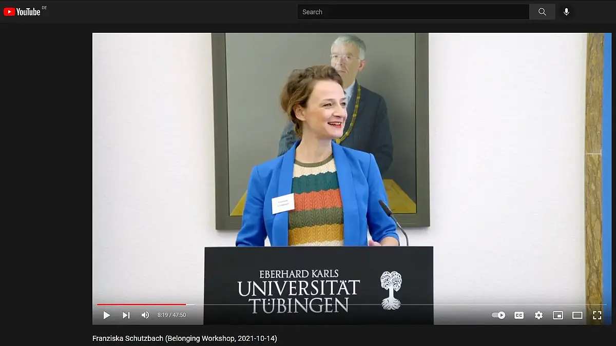 A speaker standing at a lectern