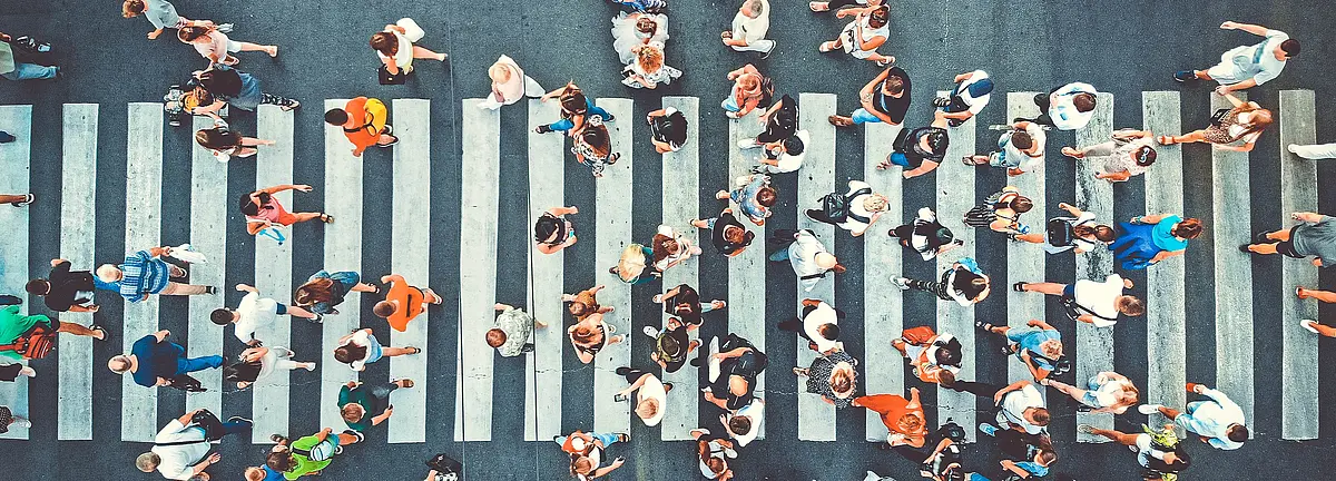 Photo of pedestrians walking across a crosswalk