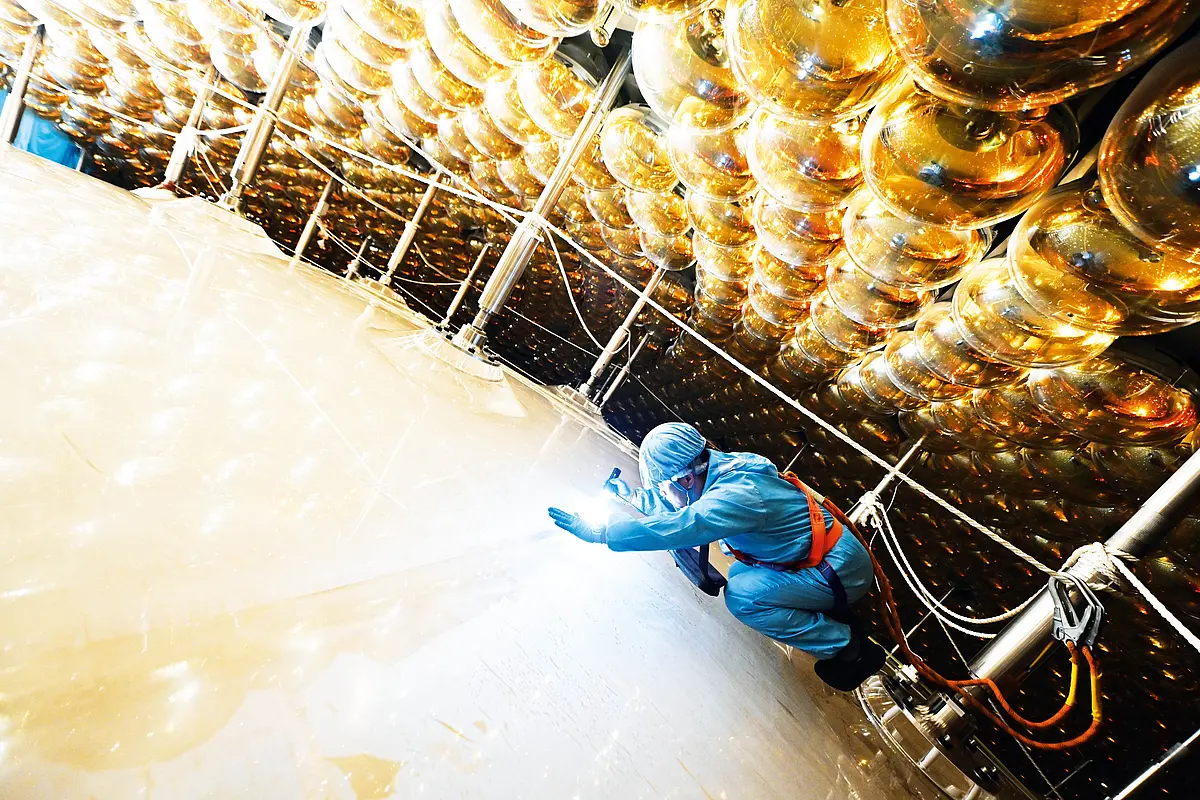 An employee inspects the acrylic sphere.