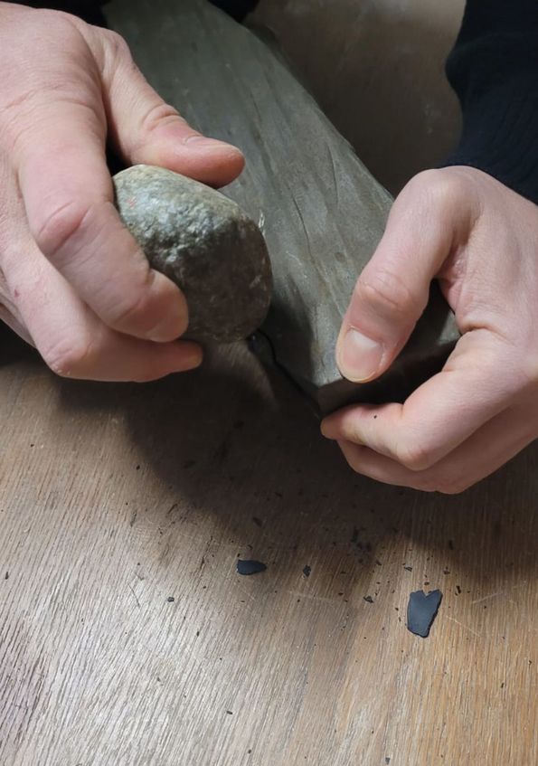 Researcher Patrick Schmidt produces a stone tool like those found in South Africa, using local material. 
