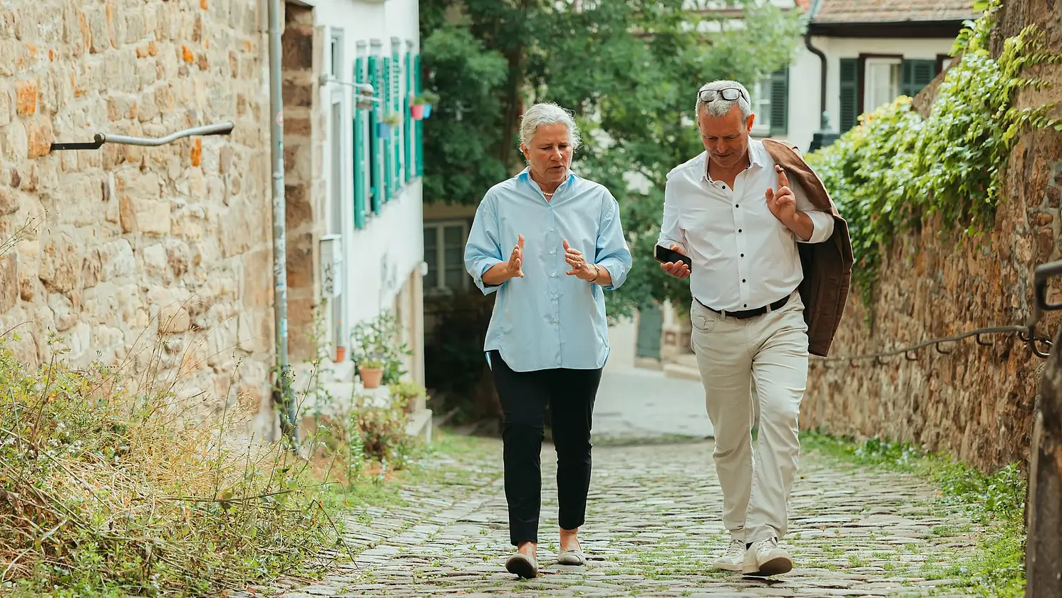 Karla Pollmann and the editor chatting in an alley in the old town