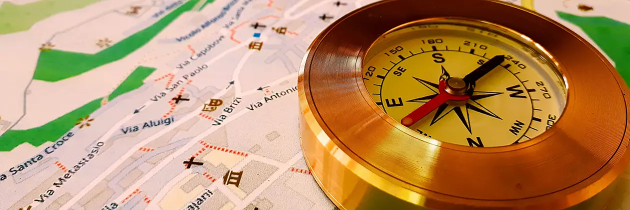 A compass lies on a map