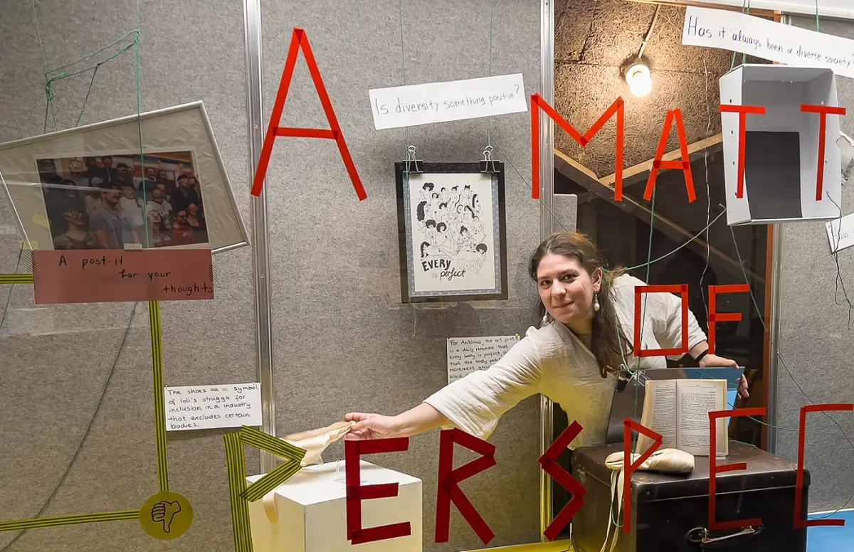 Student putting an object in a show case