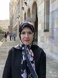 A woman in her late 30s with headscarf