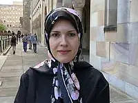 A woman in her late 30s with headscarf