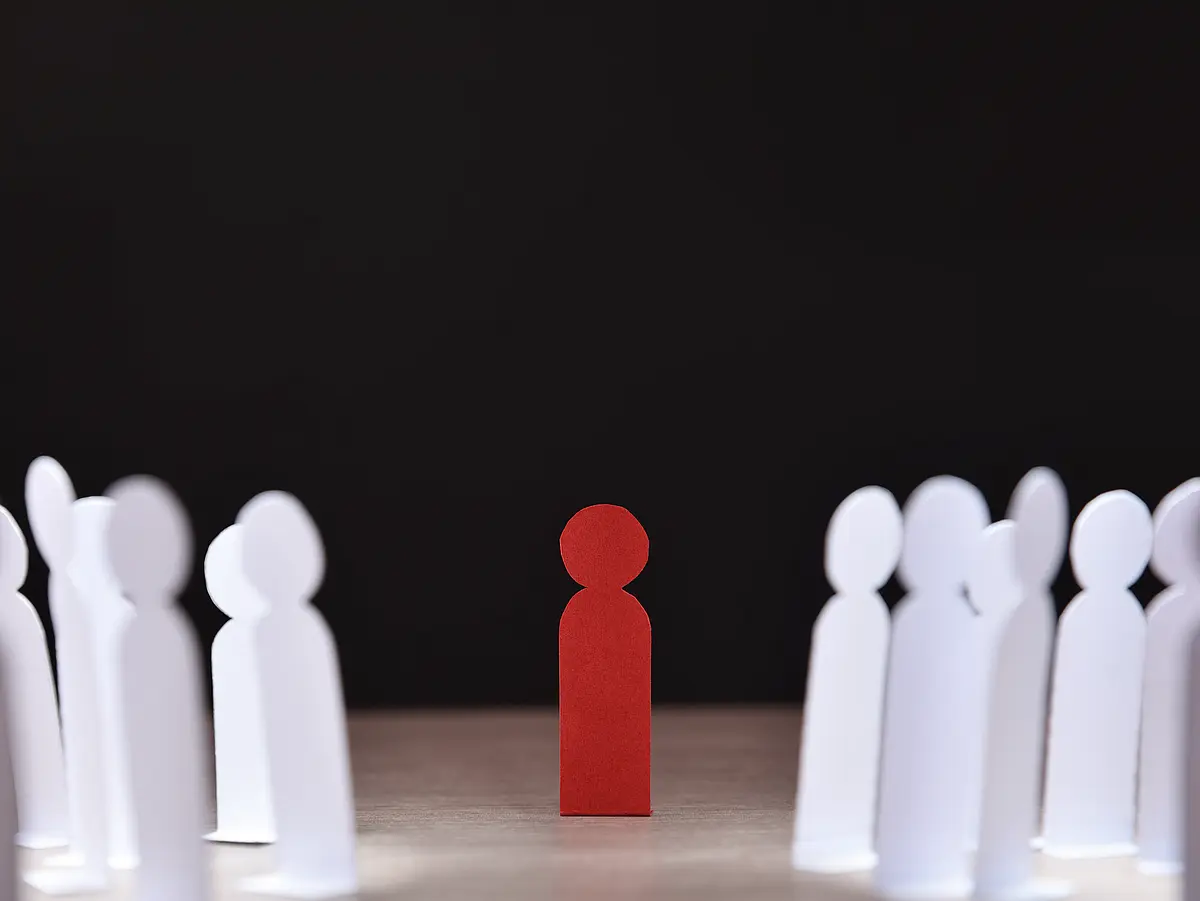 Picture with white silhouette figures circling a red figure
