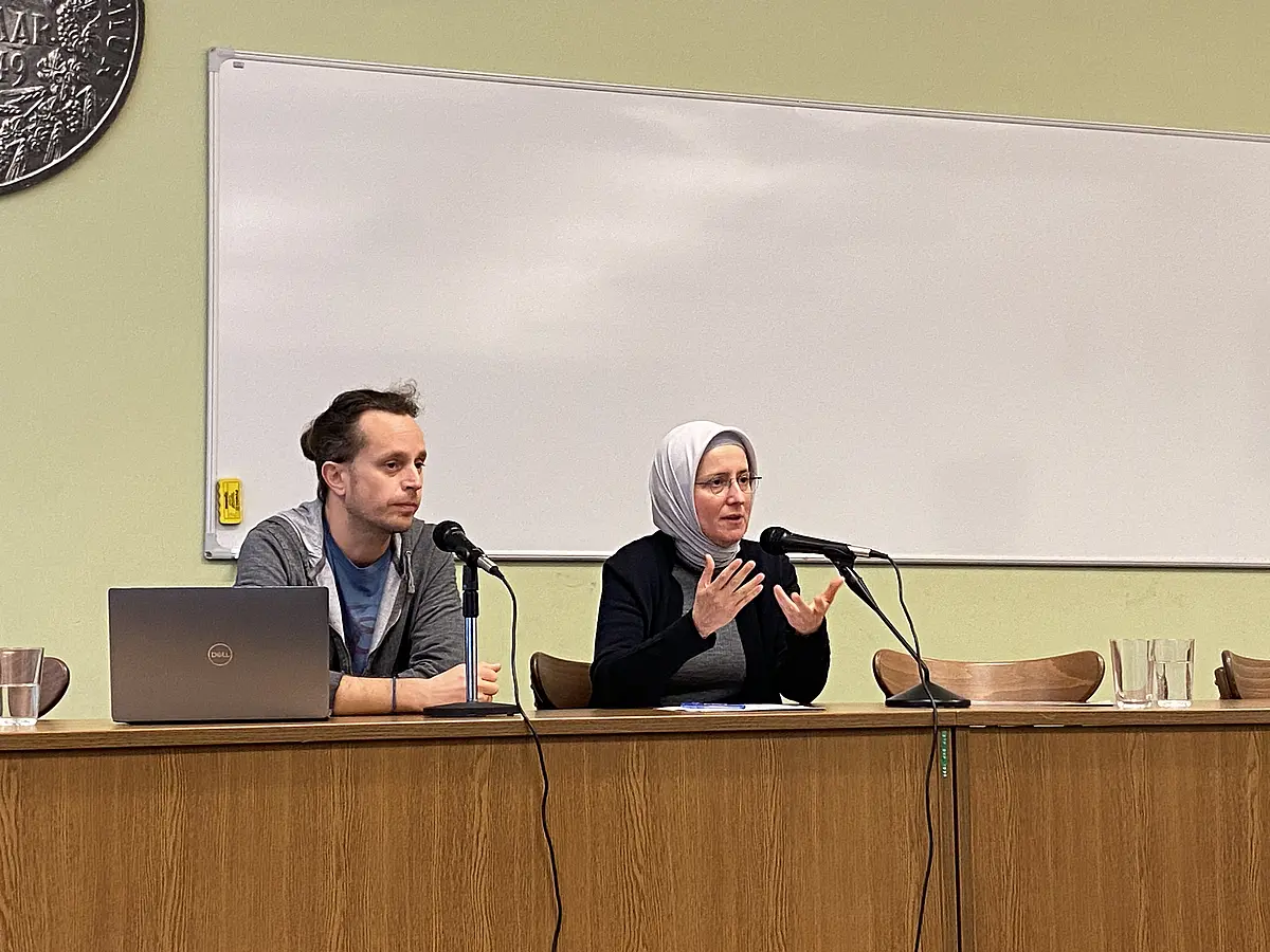 Two scholars presenting