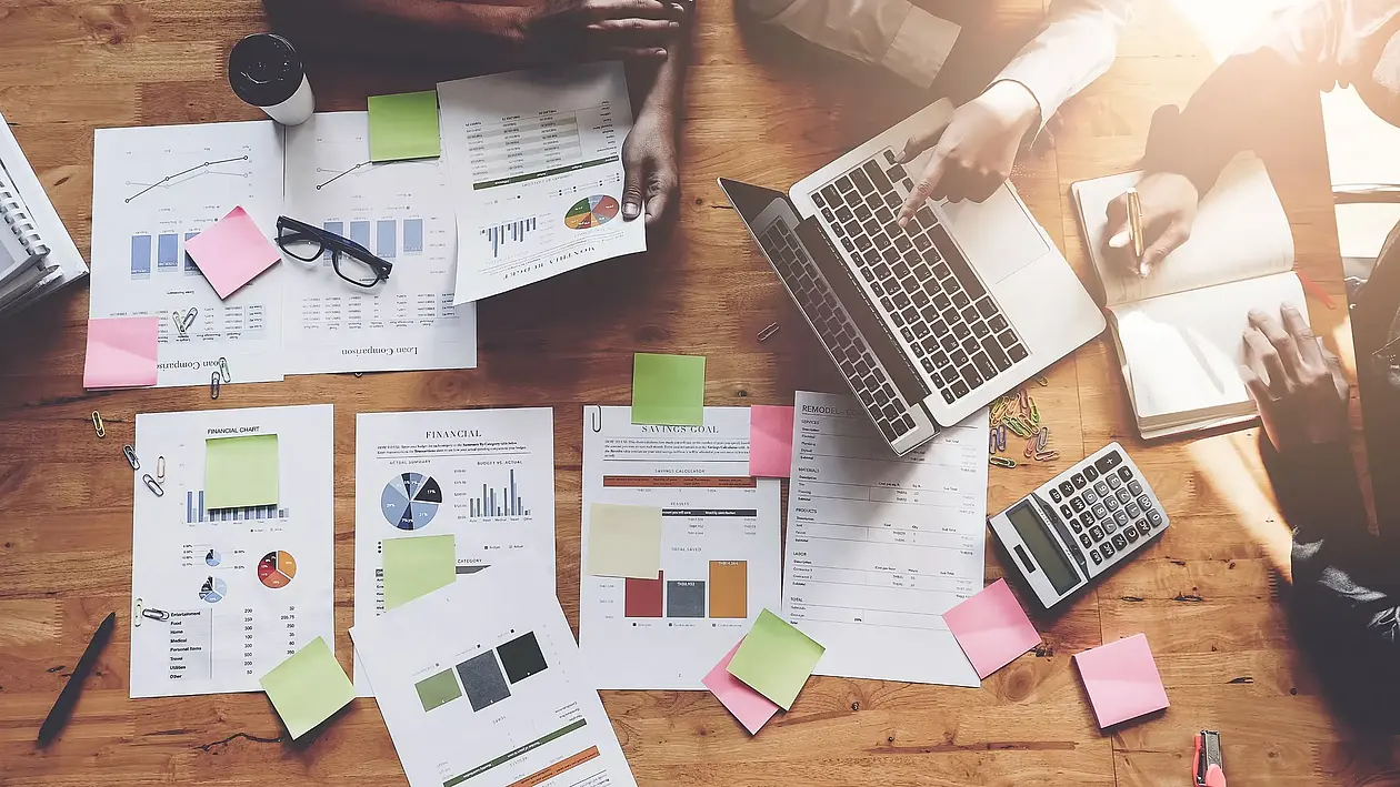 Image of a desk where several people are working on concepts.