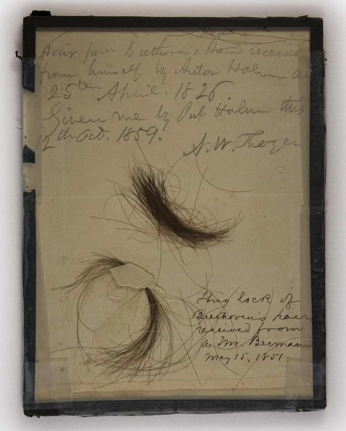 Zwei Locken auf Papier mit Beschriftung