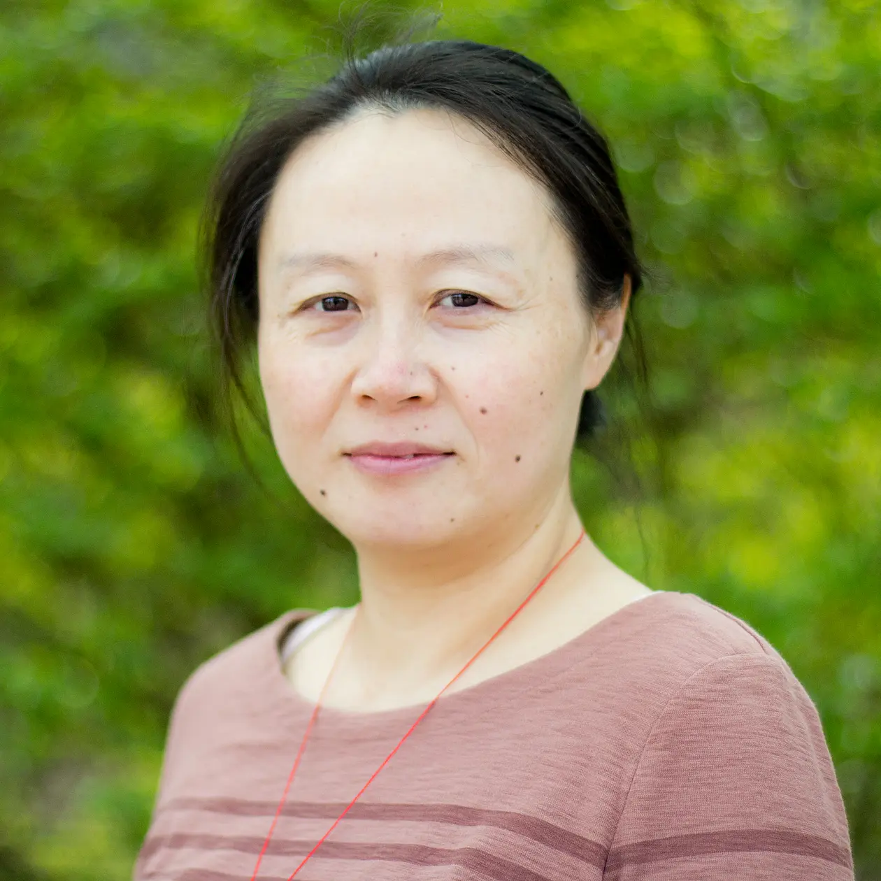Jing Hu smiles into the camera