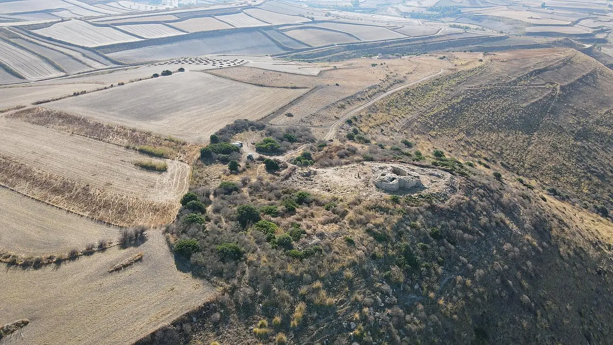 Photo of an archaeological site on a hill in a barren landscape