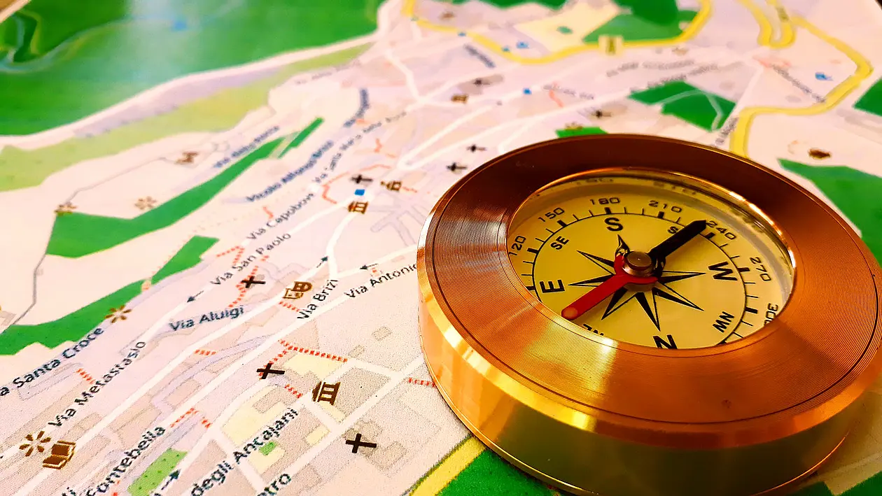 A compass lies on a map of a city