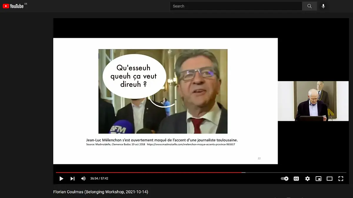 A PowerPoint presentation showing an older male politician with a speech bubble