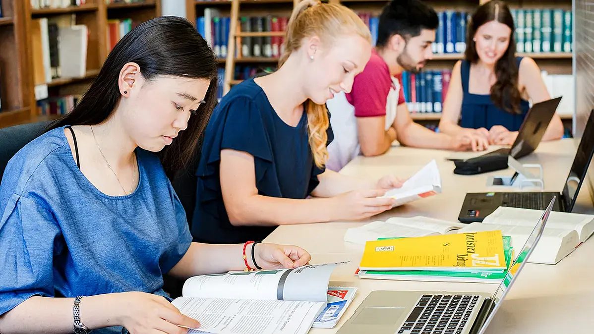 Students sitting and reading in the library
