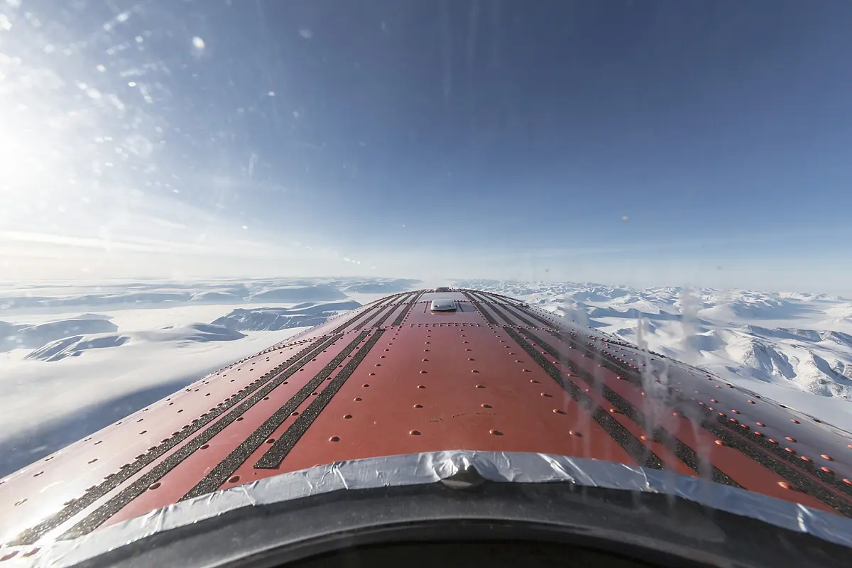 View through the window of an research aircraft above the clouds.