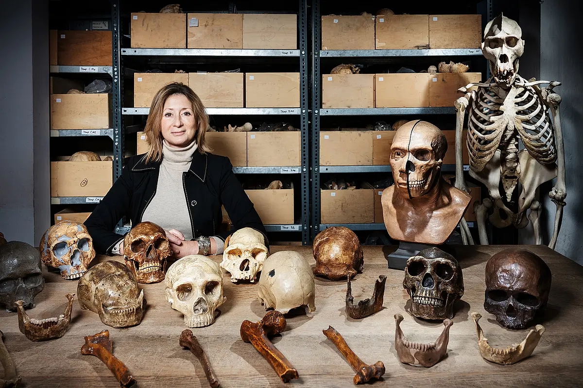 Professorin Katerina Harvati mit alten Schädeln und Knochen.