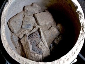 View into one of the pottery vessels with cuneiform tablets, including one tablet which is still in its original clay envelope
