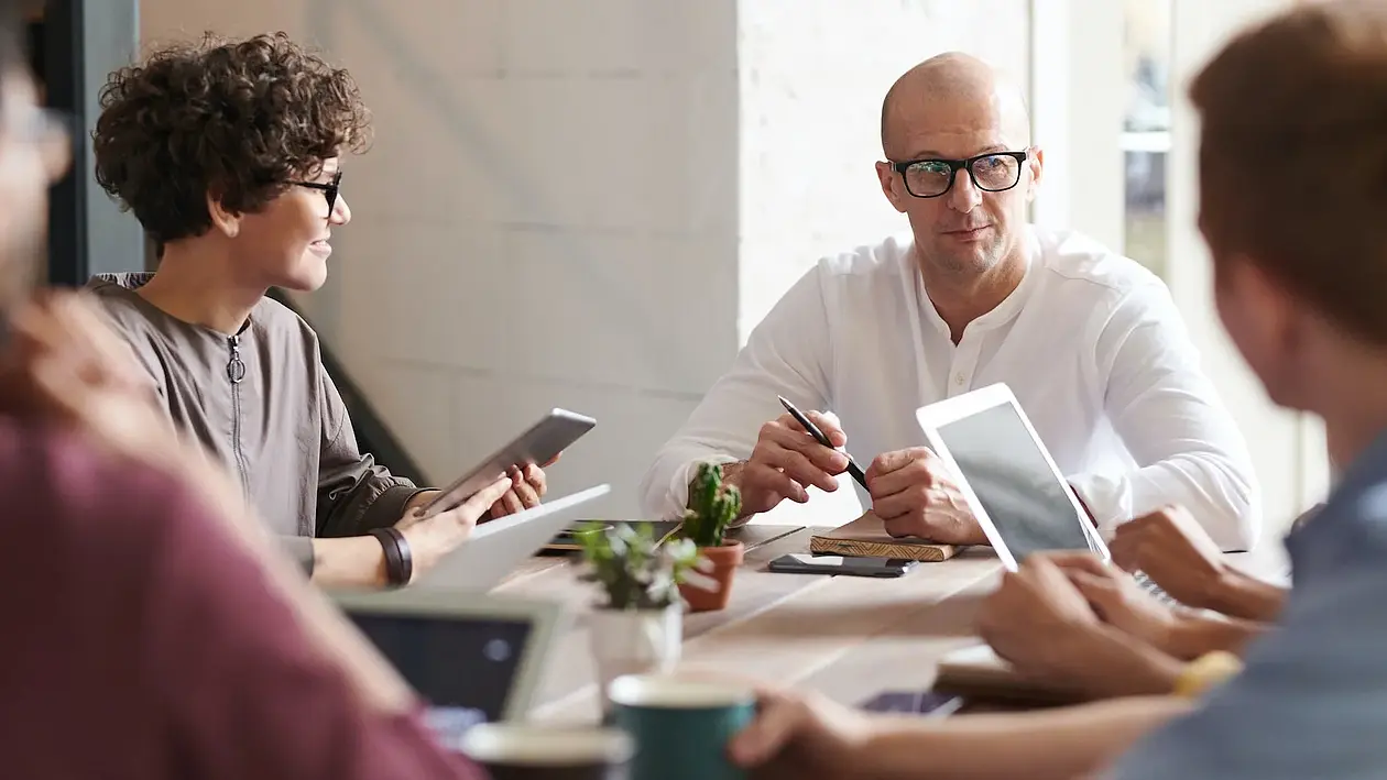 Group with laptops at table