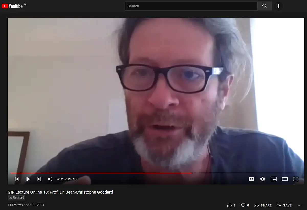 An older man with a beard talking into a webcam