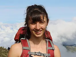 Portrait of Muriel Racky smiling into the camera.