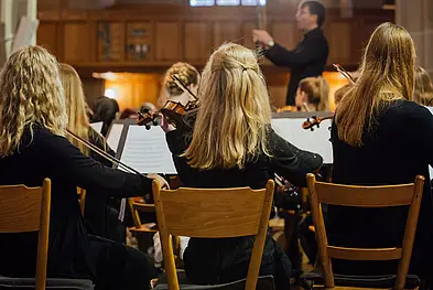 View of three violinists of the orchestra